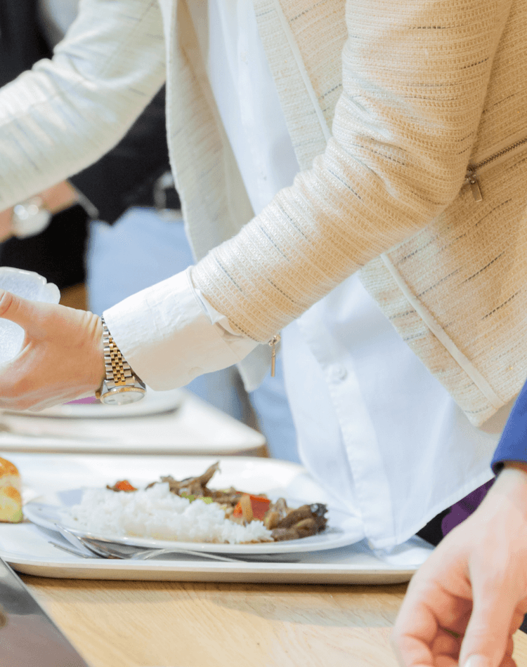 People serving themselves food & salads