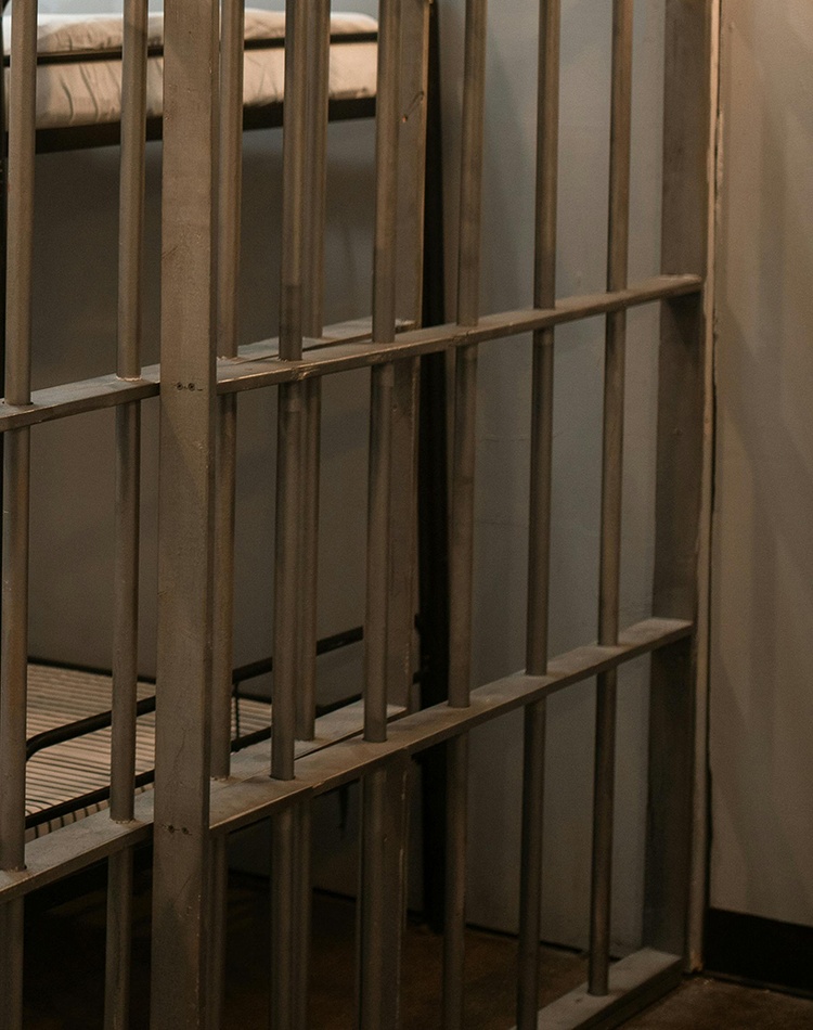 Bunk beds behind bars in prison