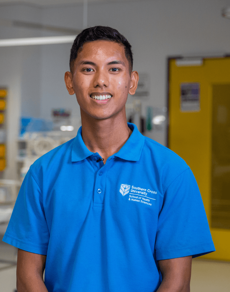 Nurse John Palencia faces camera in a hospital ward