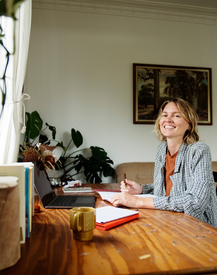 A student sitting at a desk, journaling