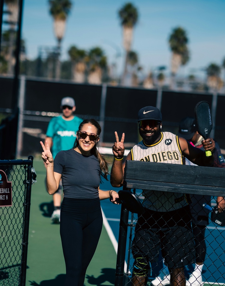 Students smiling as they leave the pickle ball court