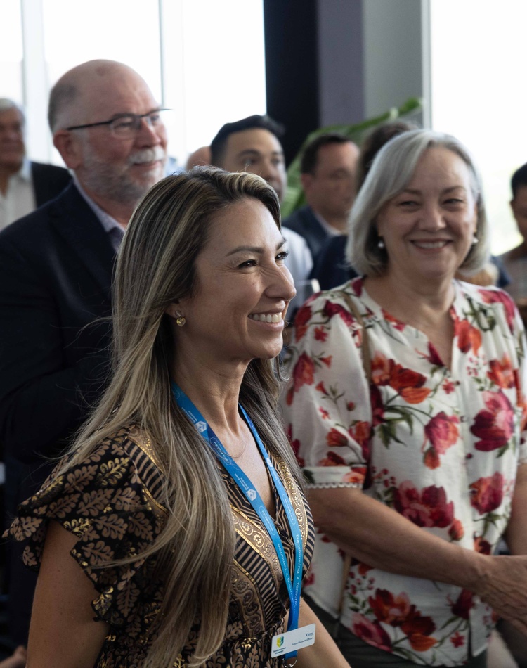 Woman walking through happy looking crowd