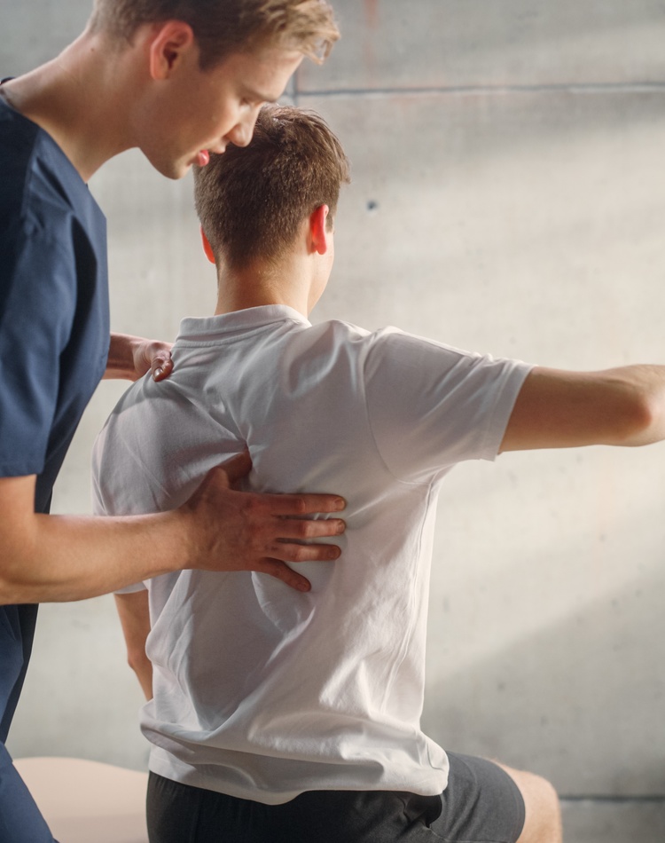 Physio working on a clients back.
