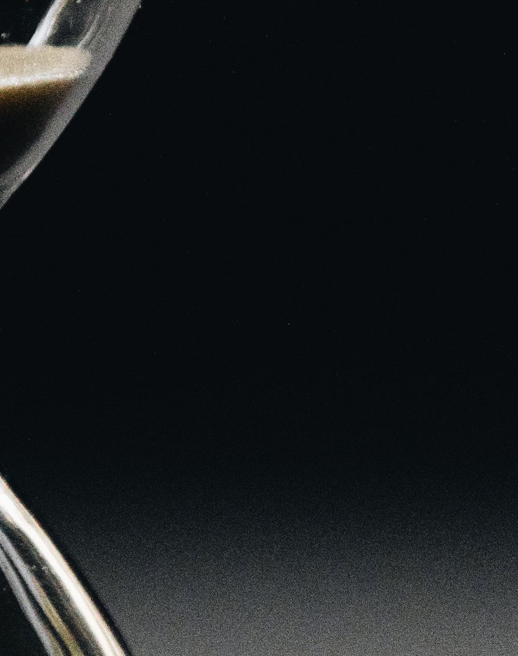 Close-up of sand falling through hourglass