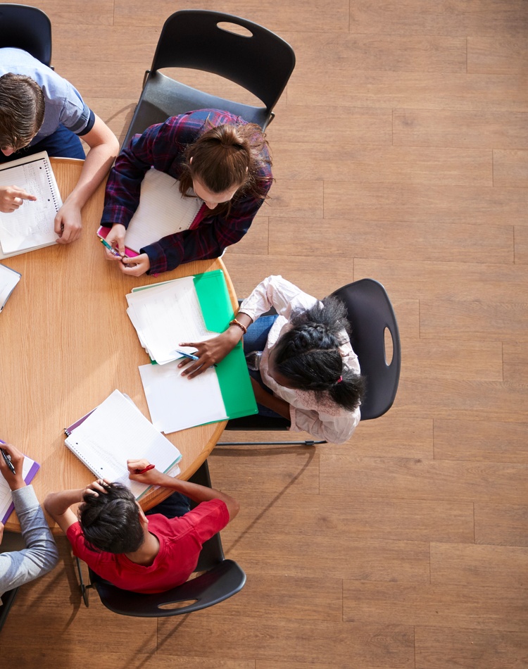 students in a circle collaborating and learning