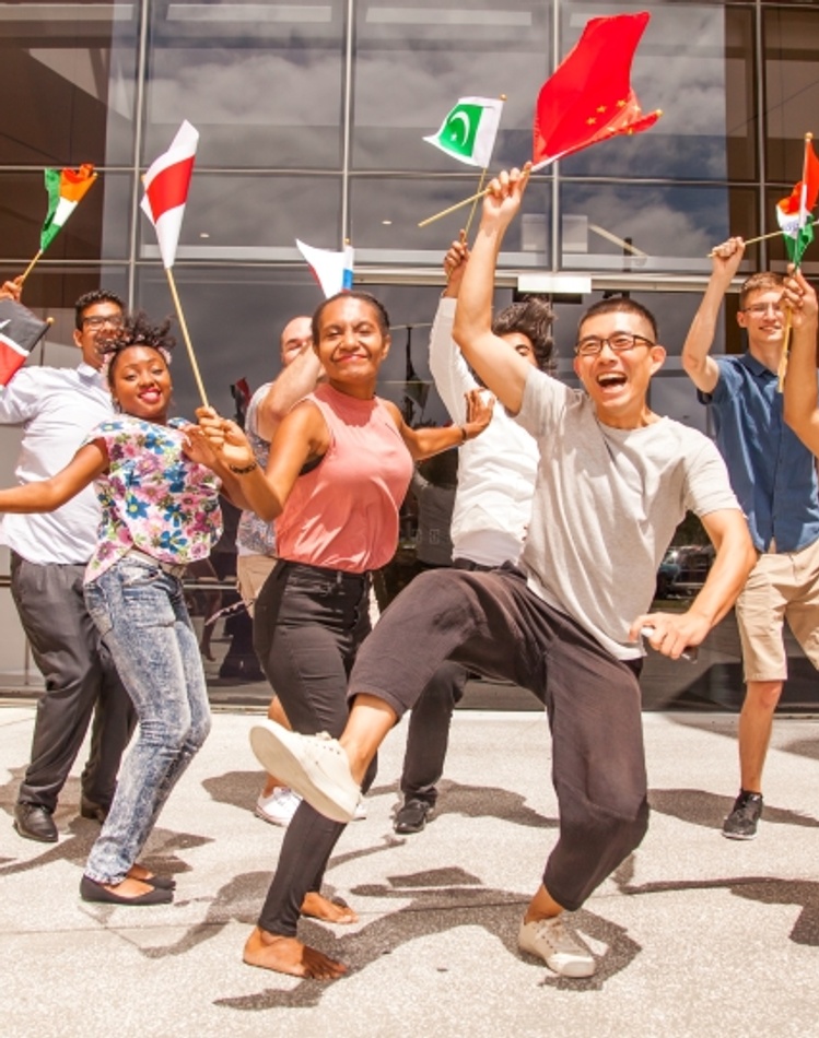 Students dancing with international flags