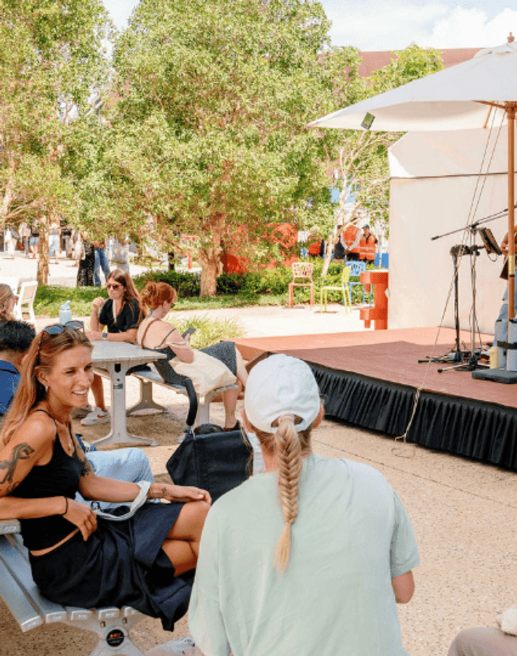 Students watching a musician