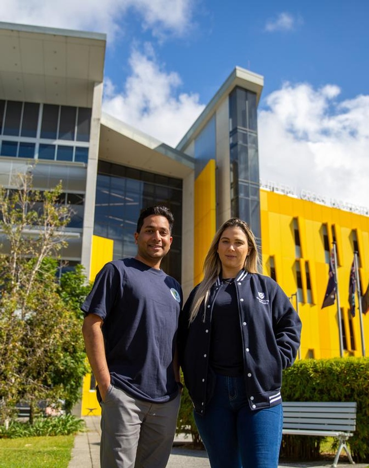 2 students standing smiling