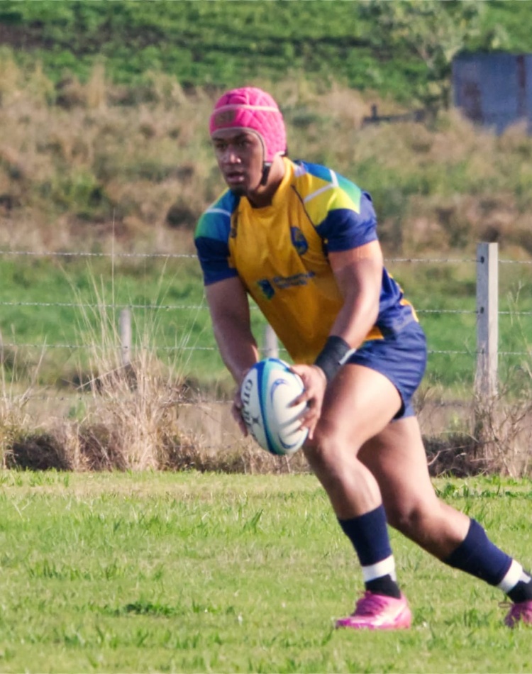 Man playing ruby about to kick the ball
