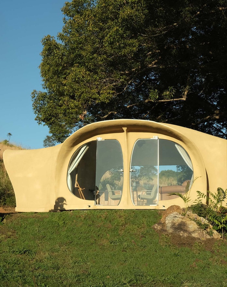 An organic shaped tiny house in a natural setting