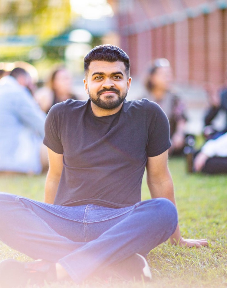 Coffs Harbour student sitting on grass