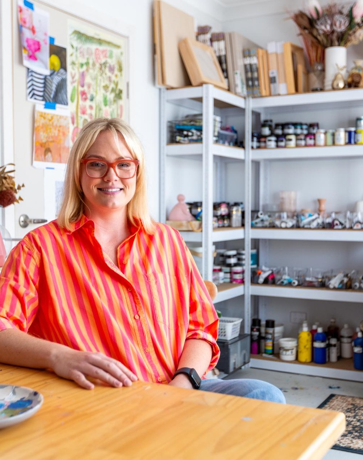 Student sitting at a desk with art supplies