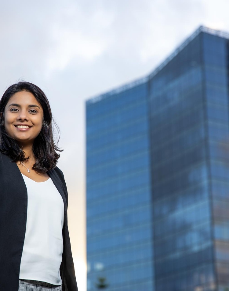 Lady smiling infront of building
