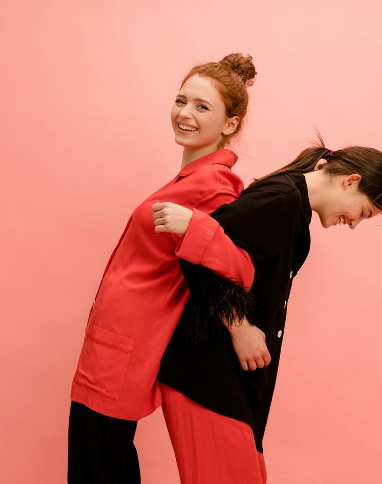 Two women linking arms