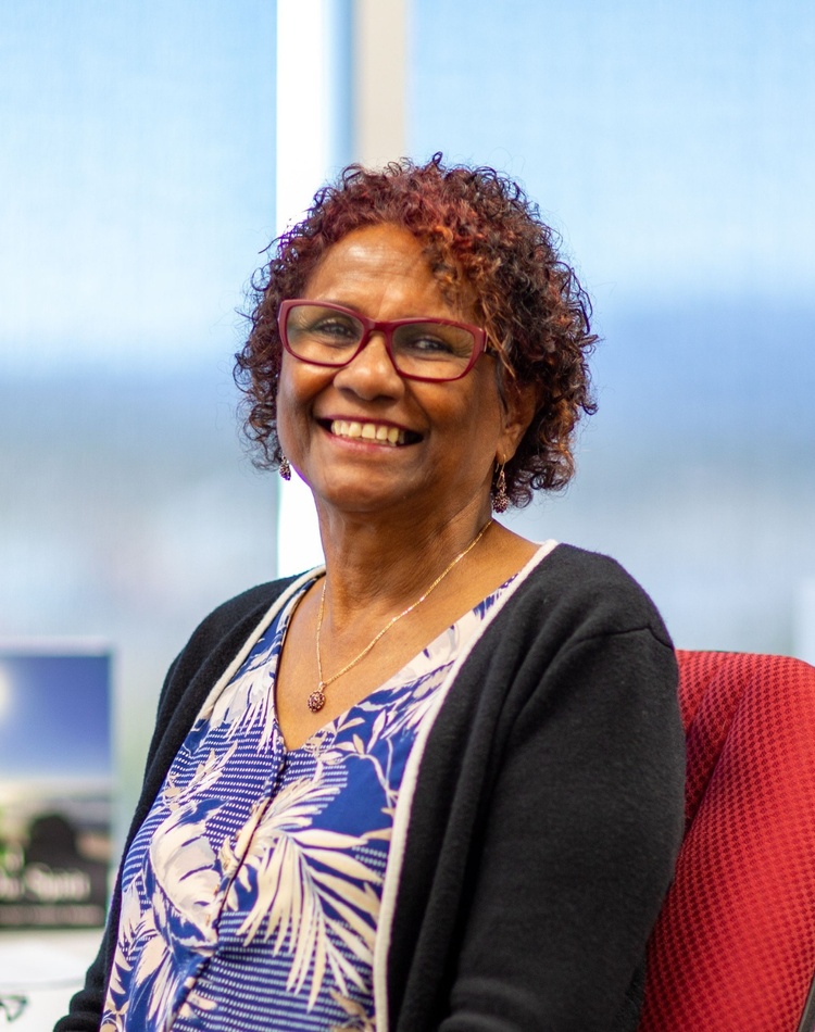 Darlene Rotumah sits at her desk