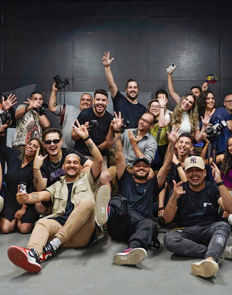 Large group of students cheering with hands in the air