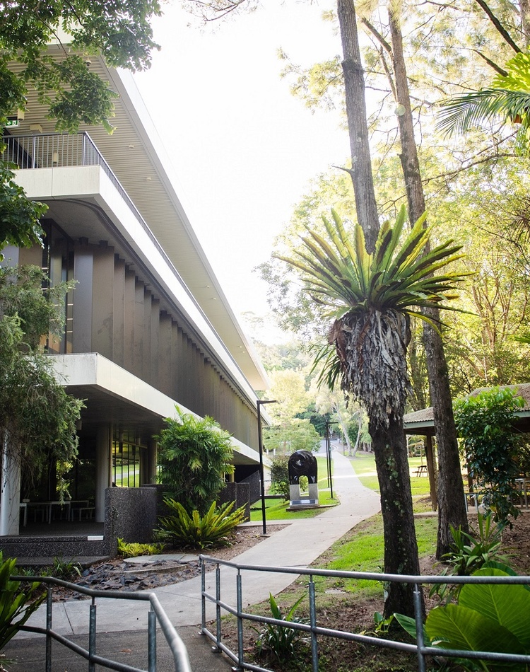 Corner of a modern building surrounded by rainforest