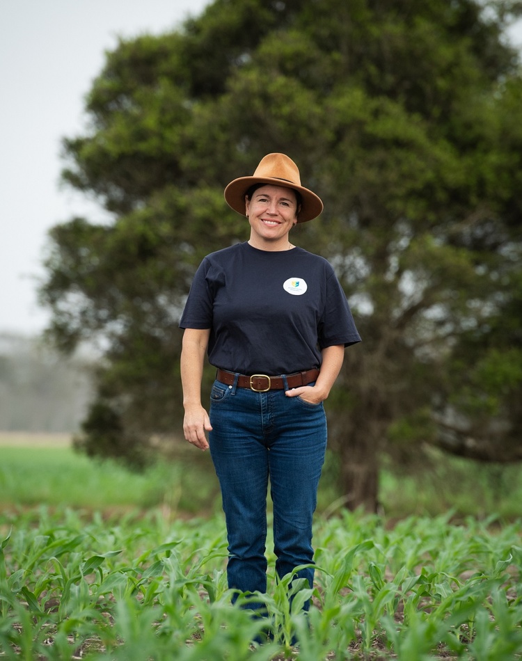 A woman stands in a field of corn