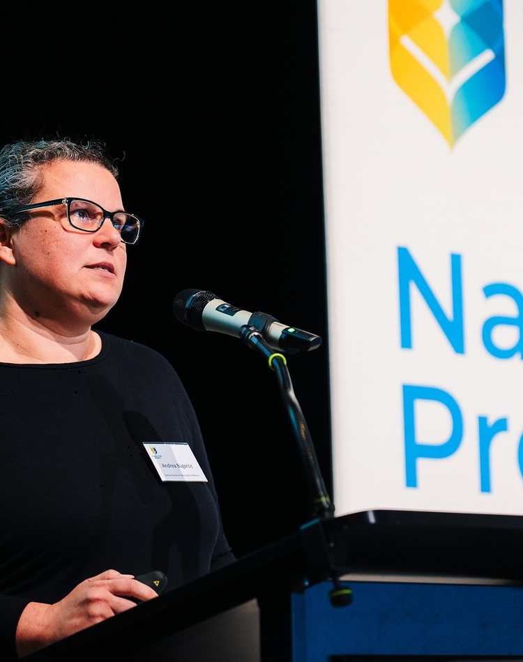 A woman standing at a lectern