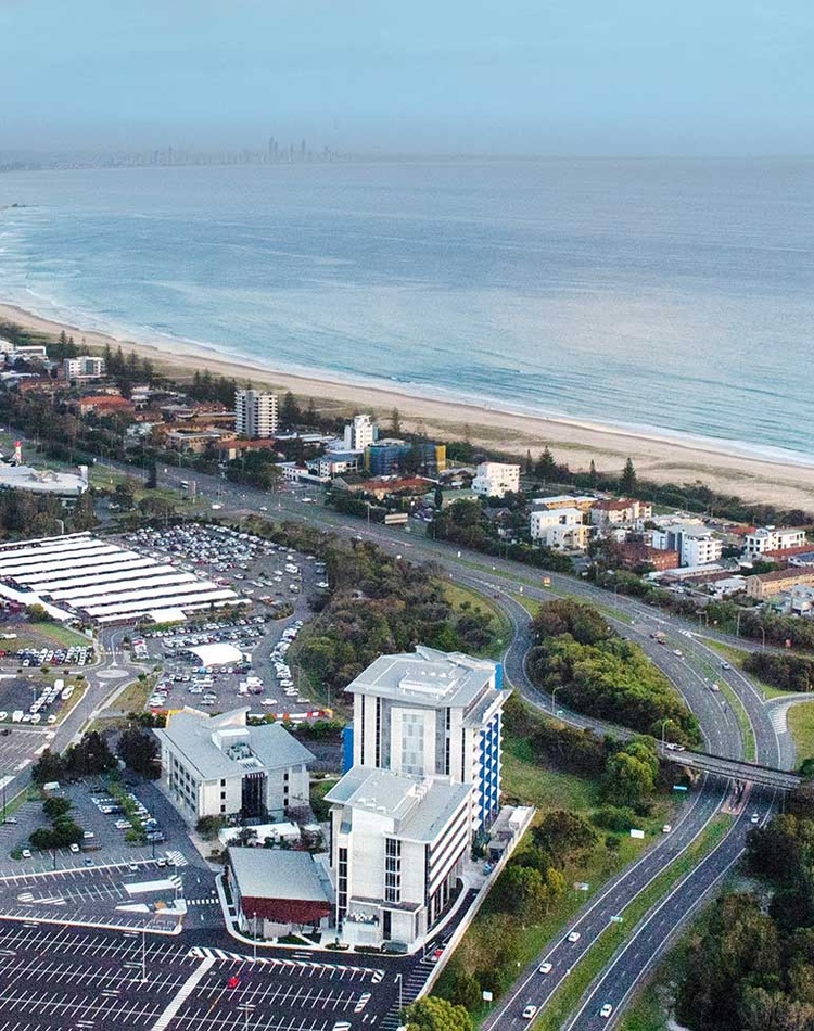 An aerial view of Southern Cross Univerity Gold Coast campus, you can see the campus and gold coast airport in the bottom of the shot and the gold coast stretching away to surfers paradise at the to pof the shot