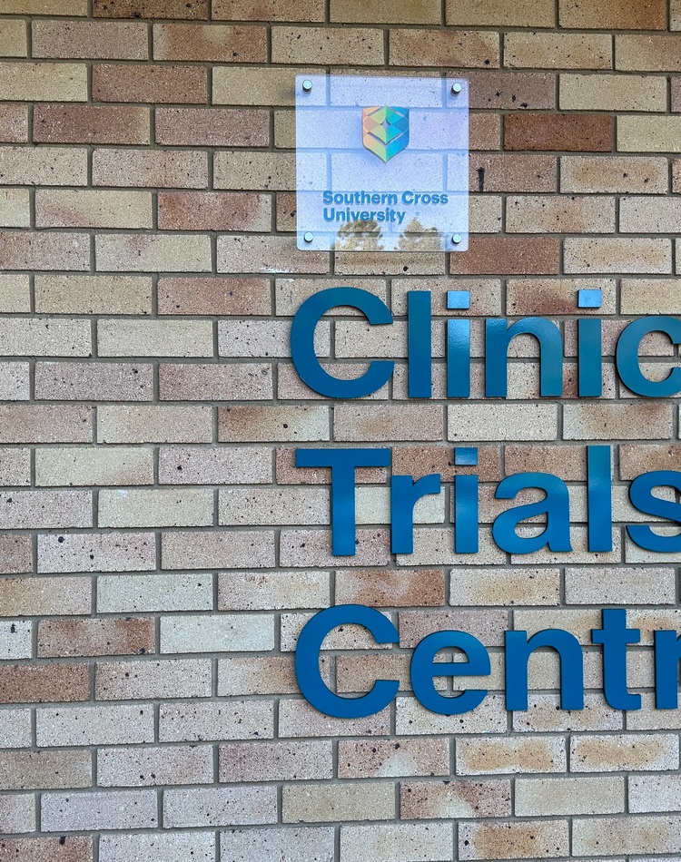 A brick facade with signage saying Clinical Trials Centre