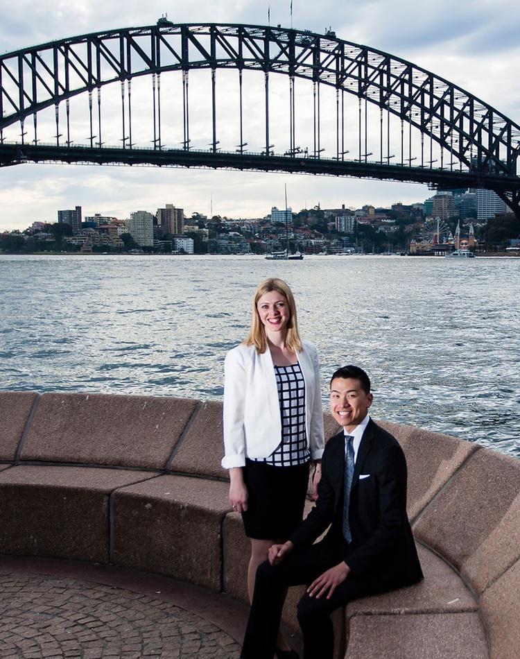 Two students at Bennelong Point with Sydney Harbour Bridge in background