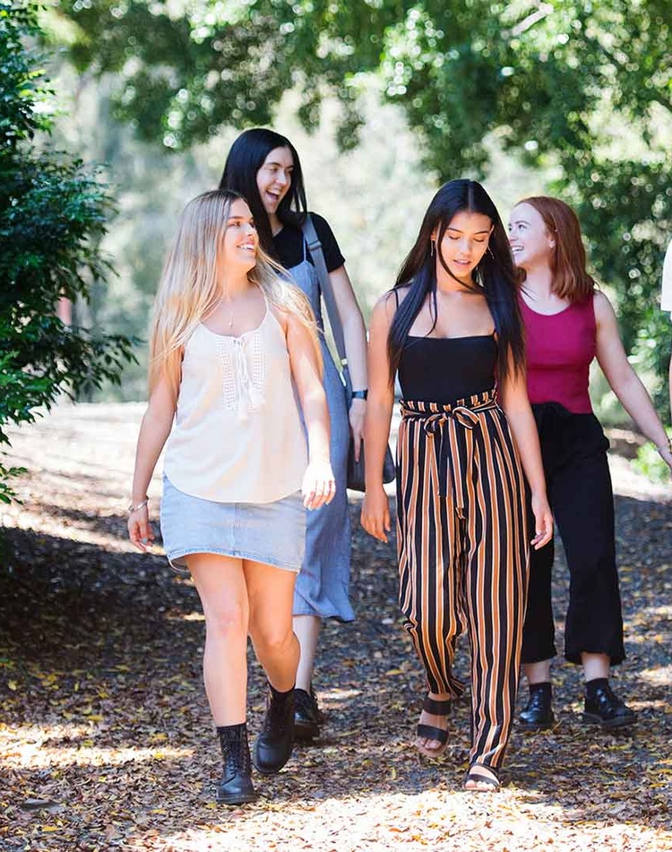 Students walking along path talking