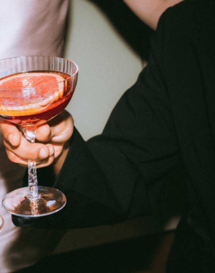 Hands holding cocktails in a circle