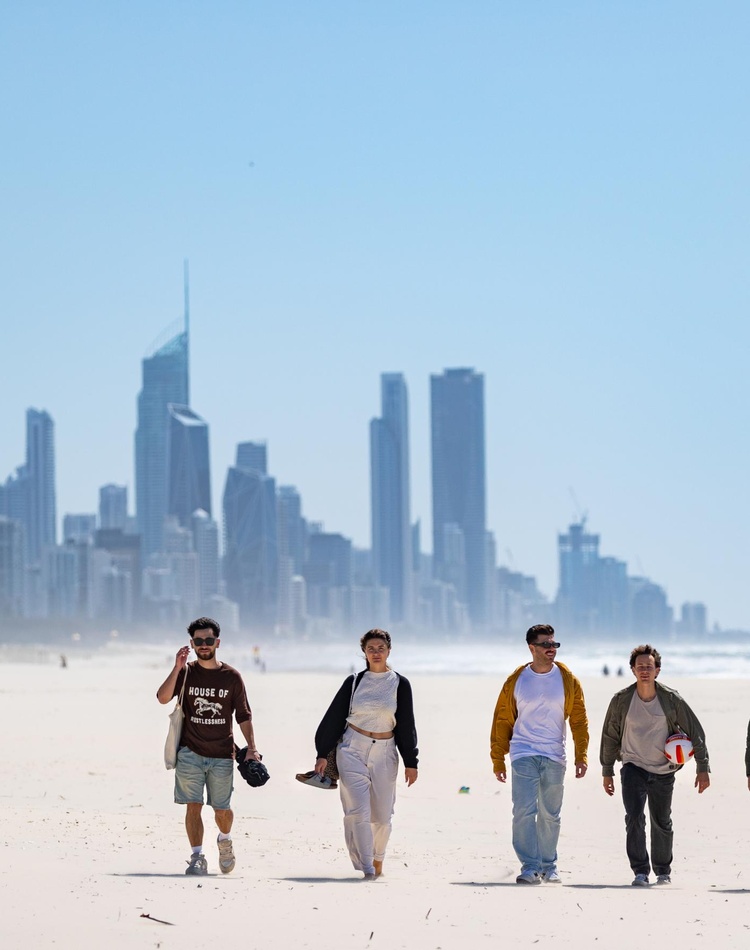 Group of study abroad students walking on North Kirra beach Gold Coast