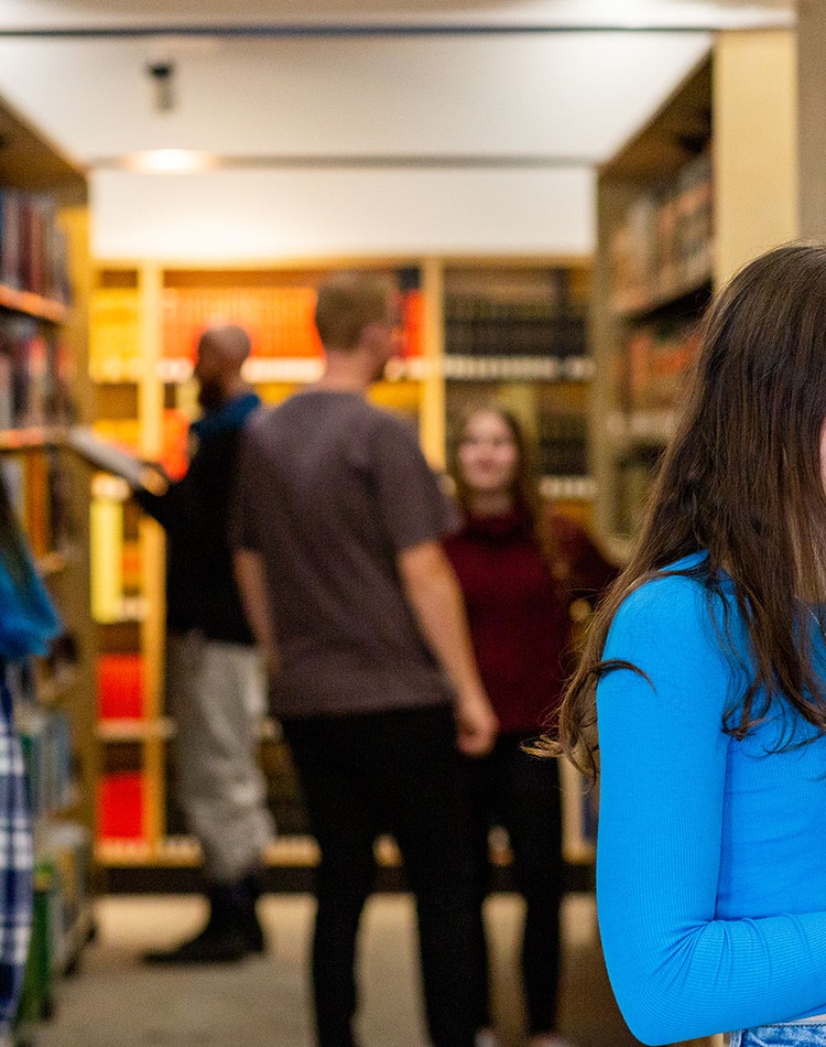 Student reading at book in a library
