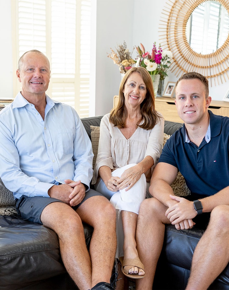 parents and son sitting on a couch