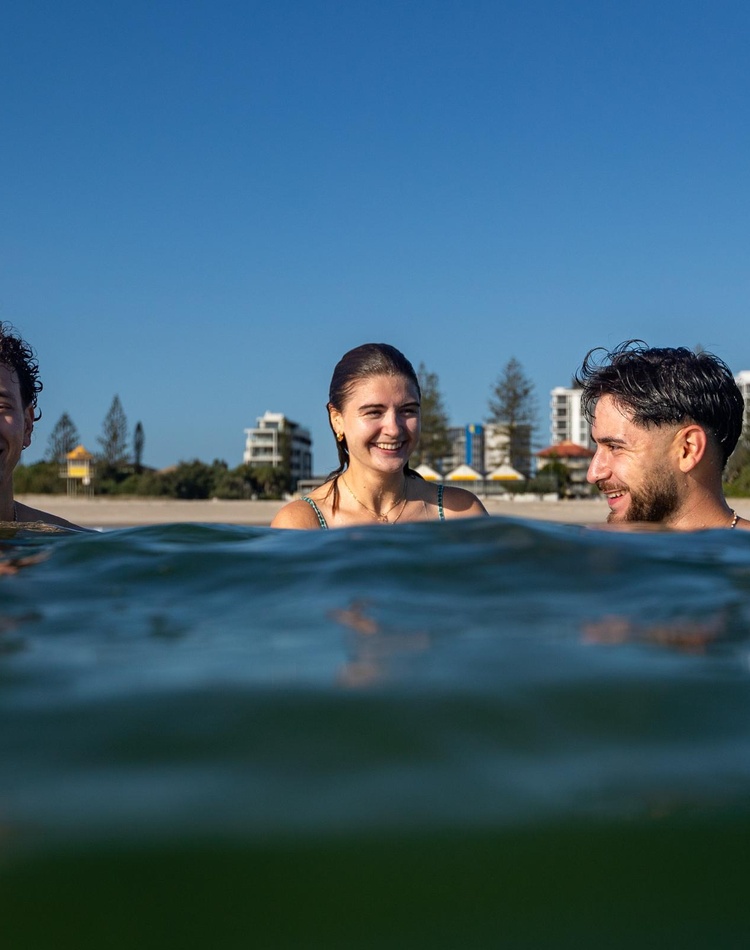 3 international students swimming in the water