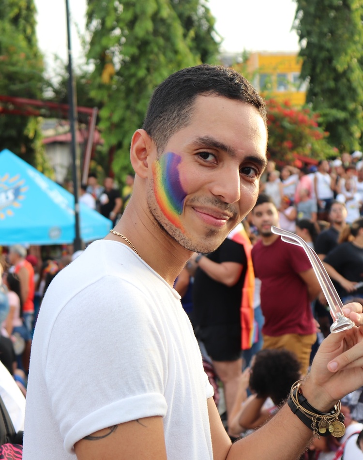 Person with rainbow painted on cheek