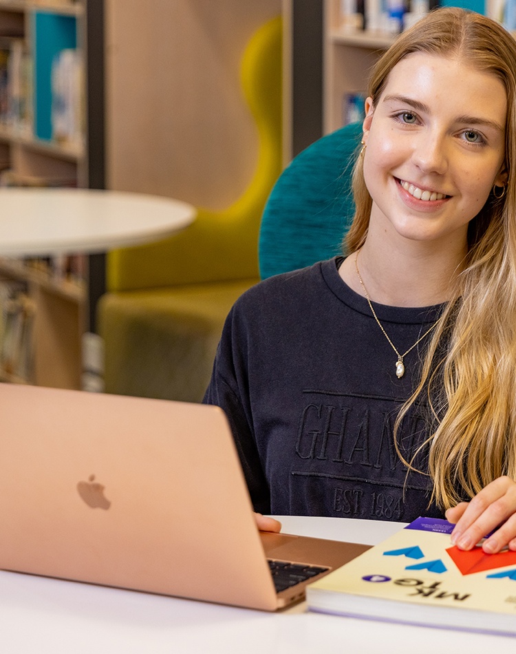student with laptop open