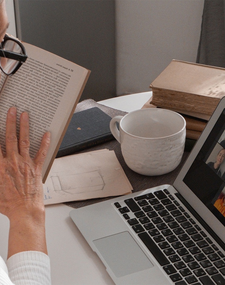 student studying with laptop showing online meeting