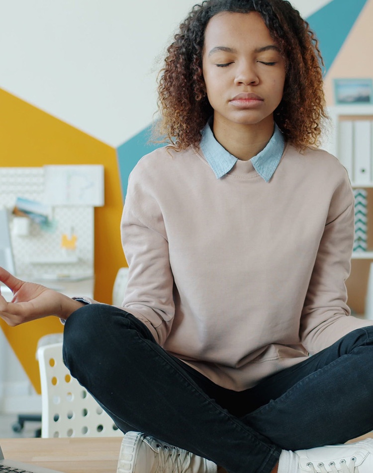 girl sitting on desk meditating