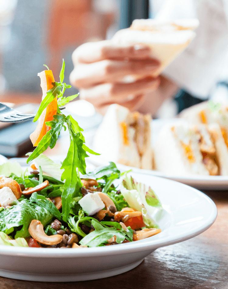 People eating sandwiches and salads