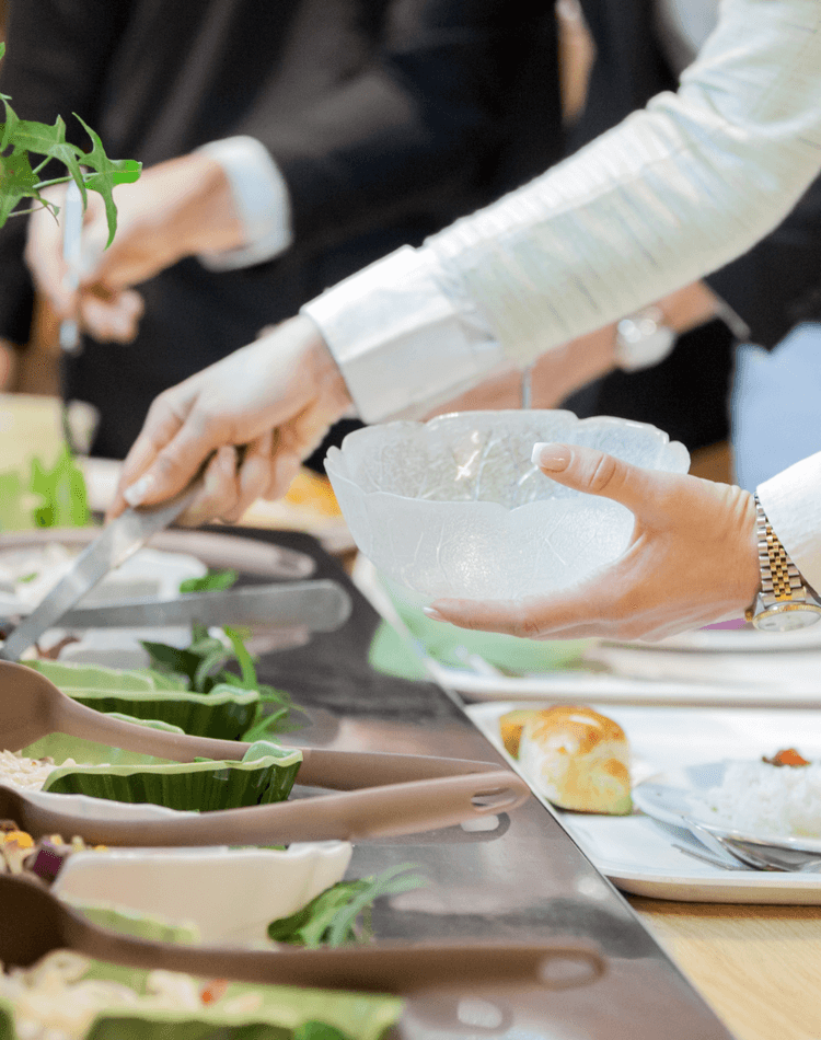 People serving themselves food & salads