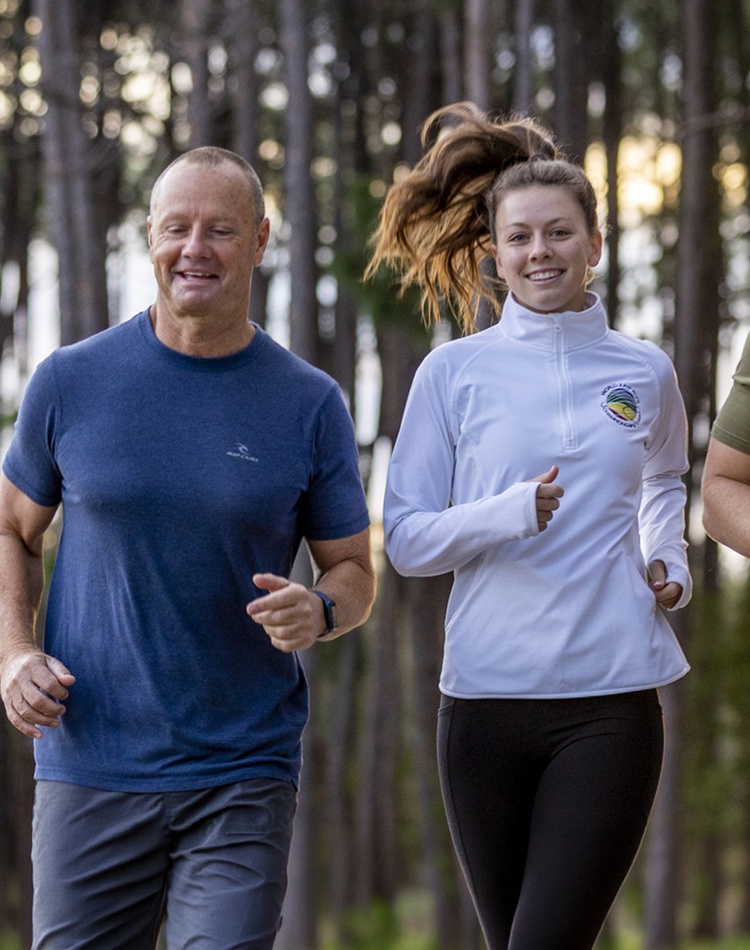 Hawkins family running through forest