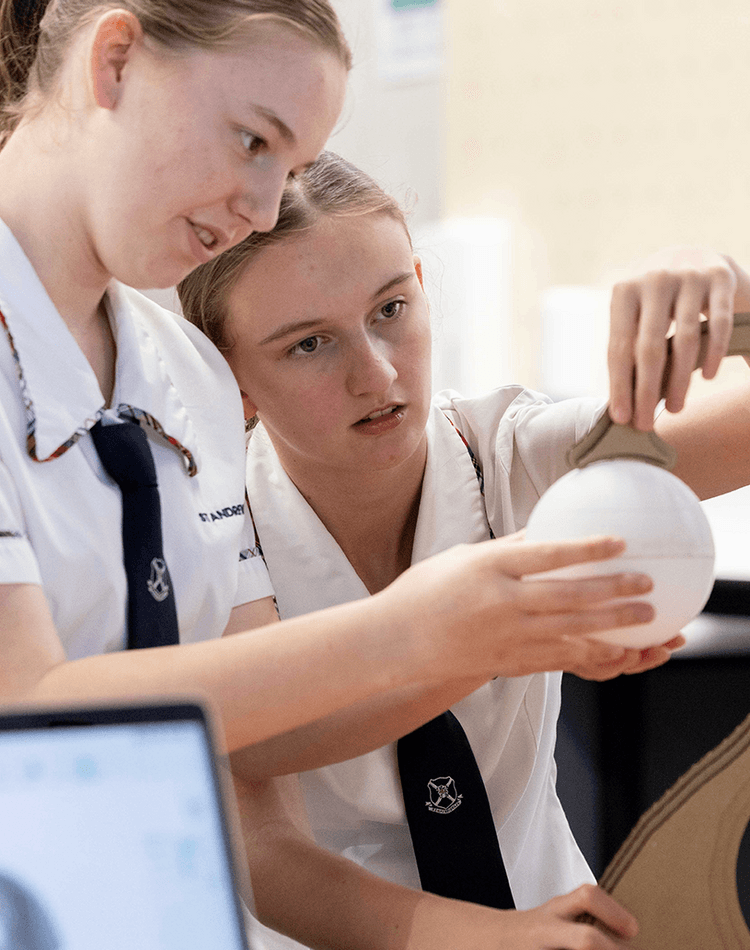 High school students interacting with sphere