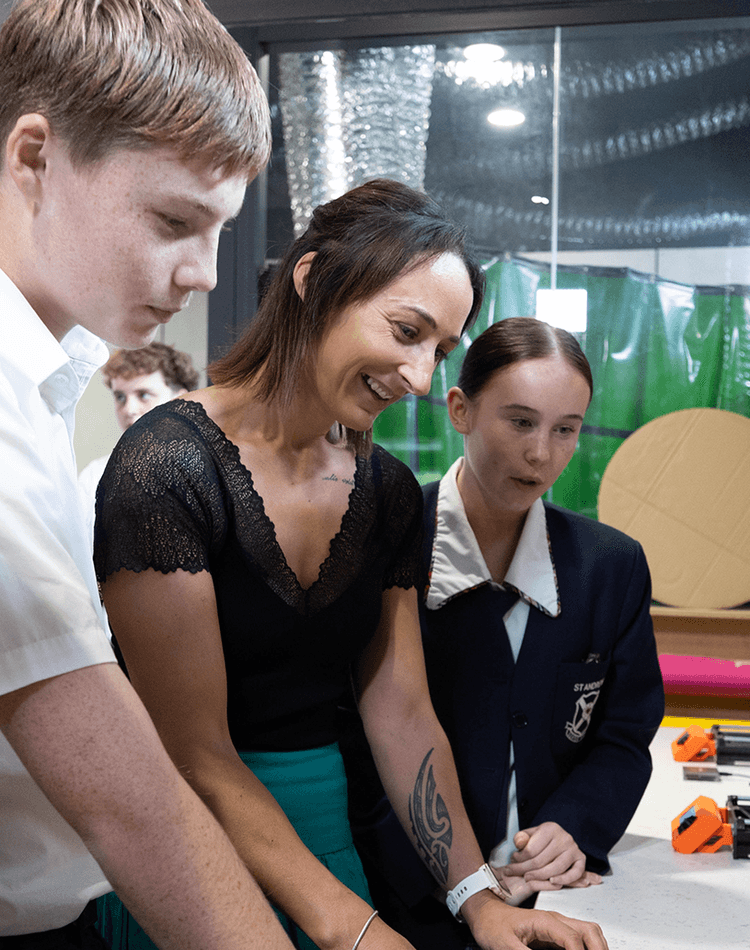 Students with teacher using equipment