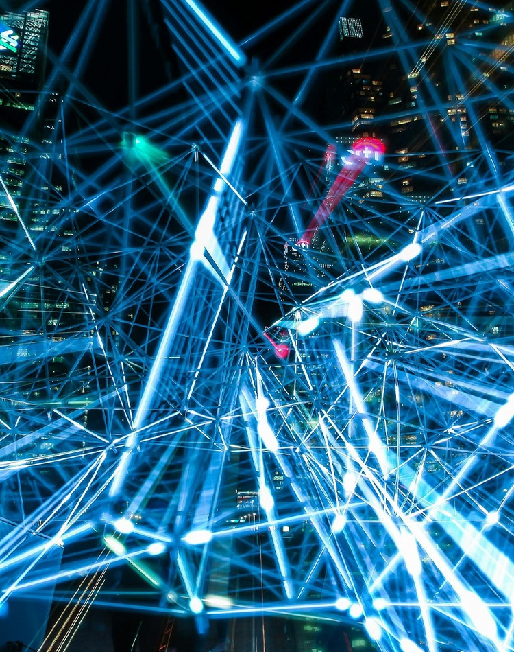 Image of blue lights connecting with a night city landscape