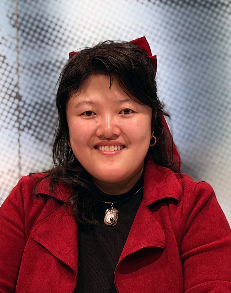 Woman in red jacket smiling at camera