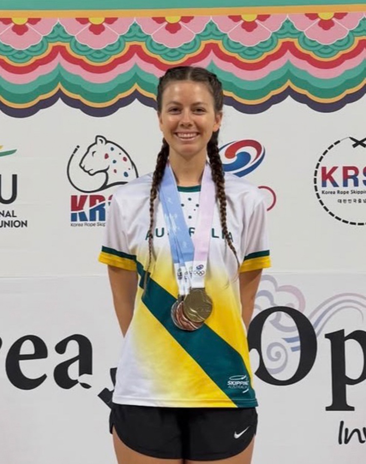 Student in athletic gear with medal