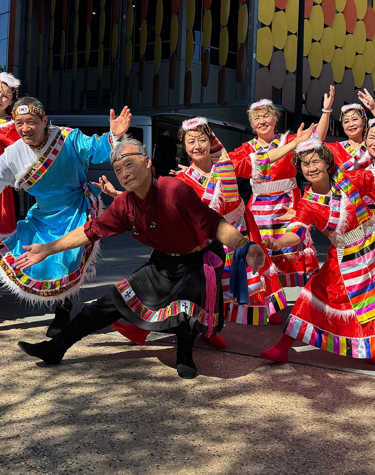 Group of people in brightly coloured traditional outfits