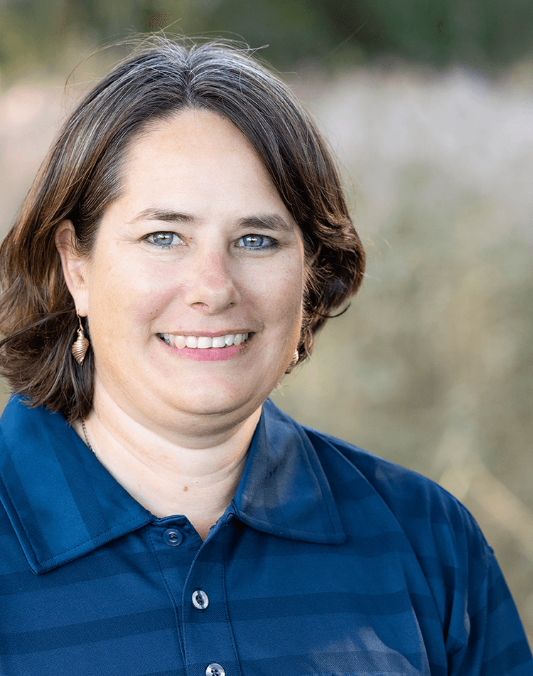 Professor Kirsten Benkendorff in blue polo smiling in a field.