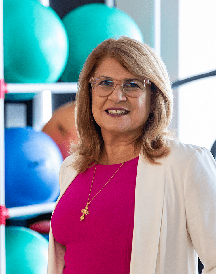 Woman in physio room with treadmill and exercise balls
