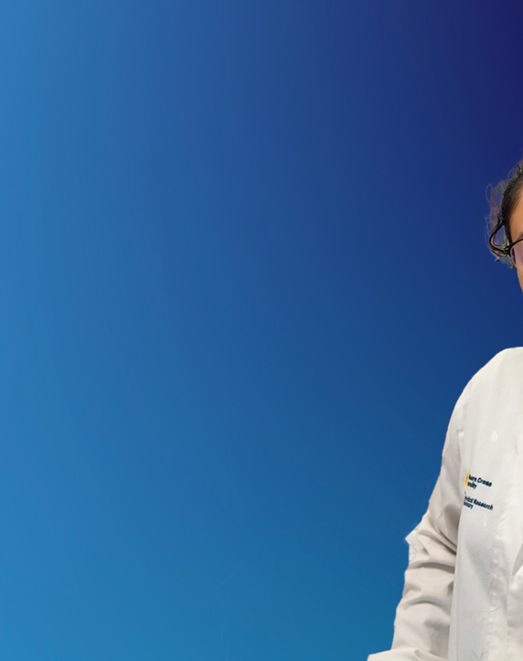 A scientist in a lab coat on a blue background
