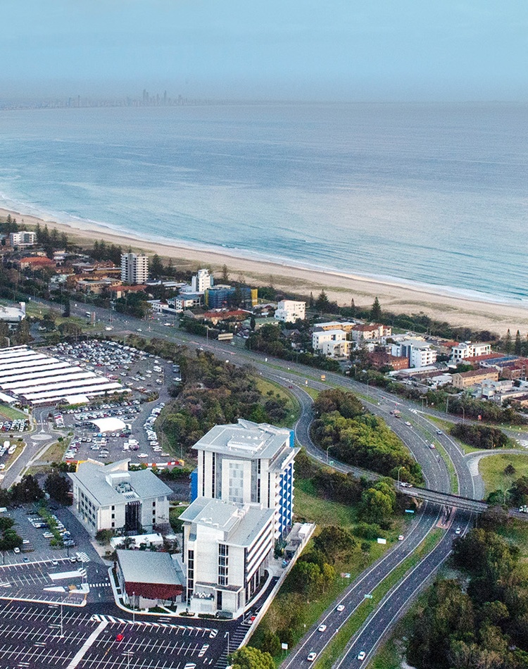 An aerial view of Southern Cross Univerity Gold Coast campus, you can see the campus and gold coast airport in the bottom of the shot and the gold coast stretching away to surfers paradise at the to pof the shot