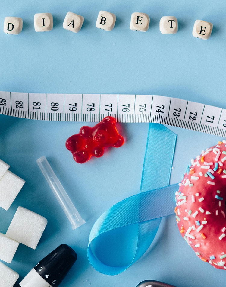 Tiles spelling word diabetes with tape measure, doughnut and sugar